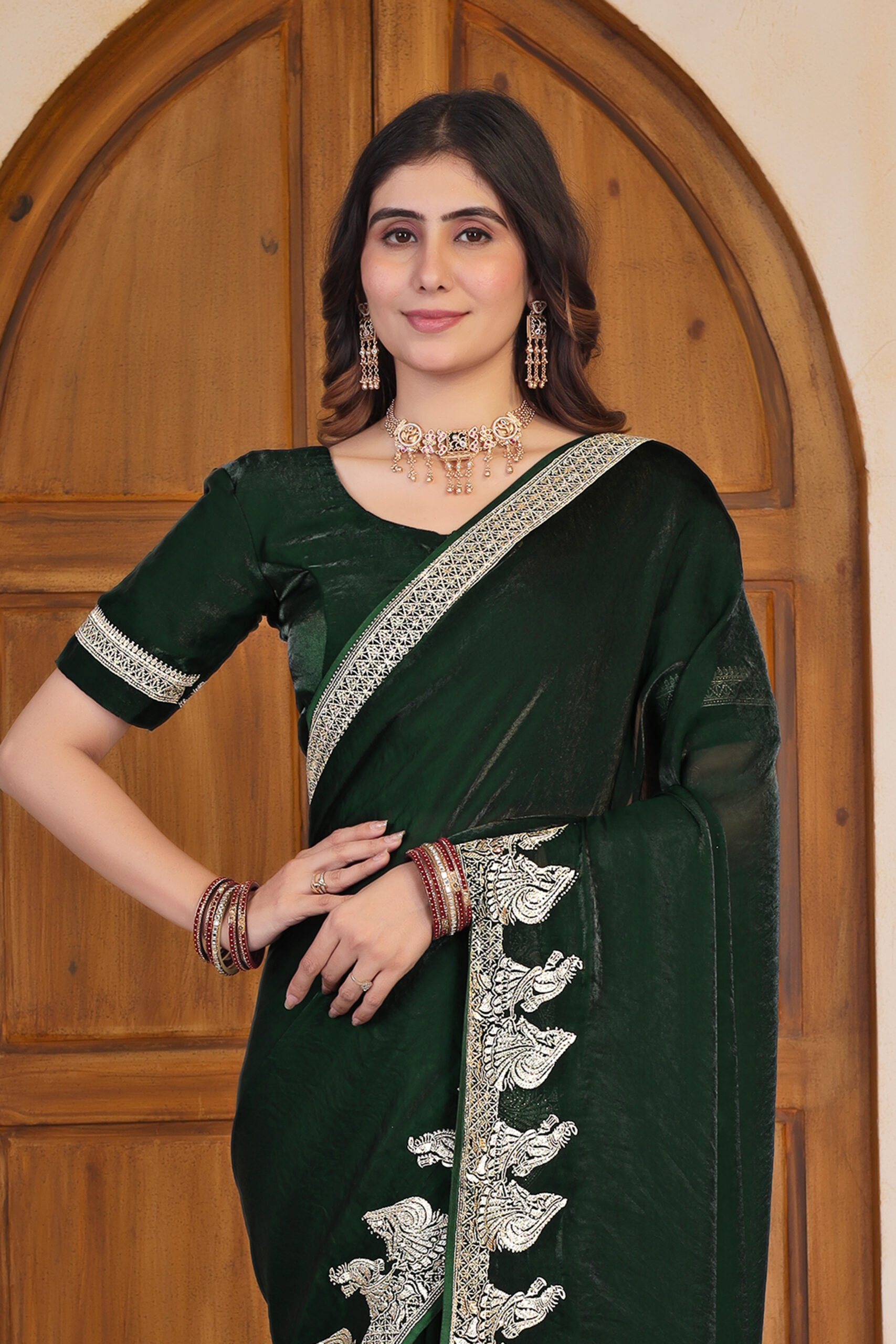 Green Fendi Satin Saree with Swarovski work and intricate embroidered border by Ritual Styles.