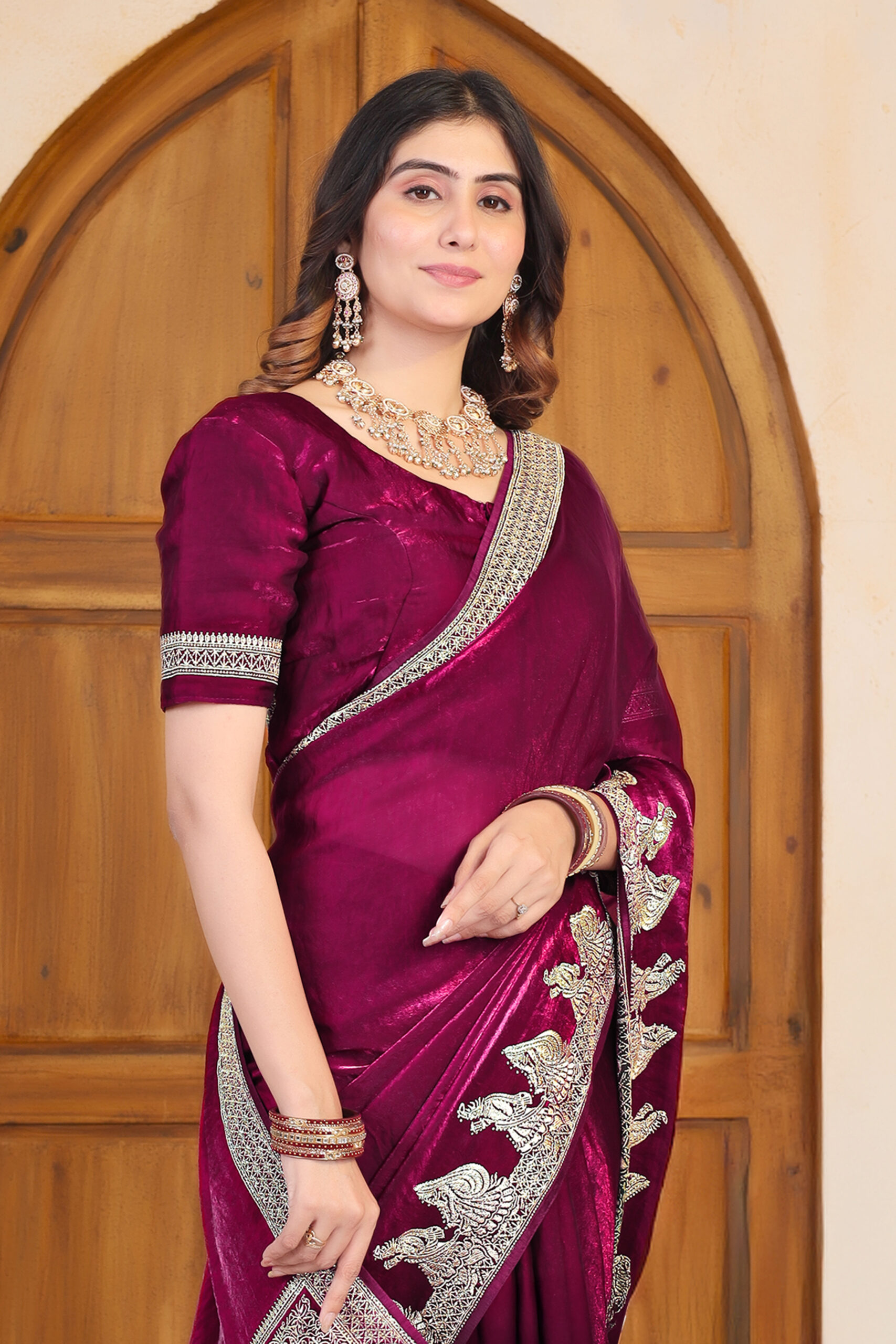 wine Fendi satin saree with Swarovski work and rich embroidered detailing by Ritual Styles.