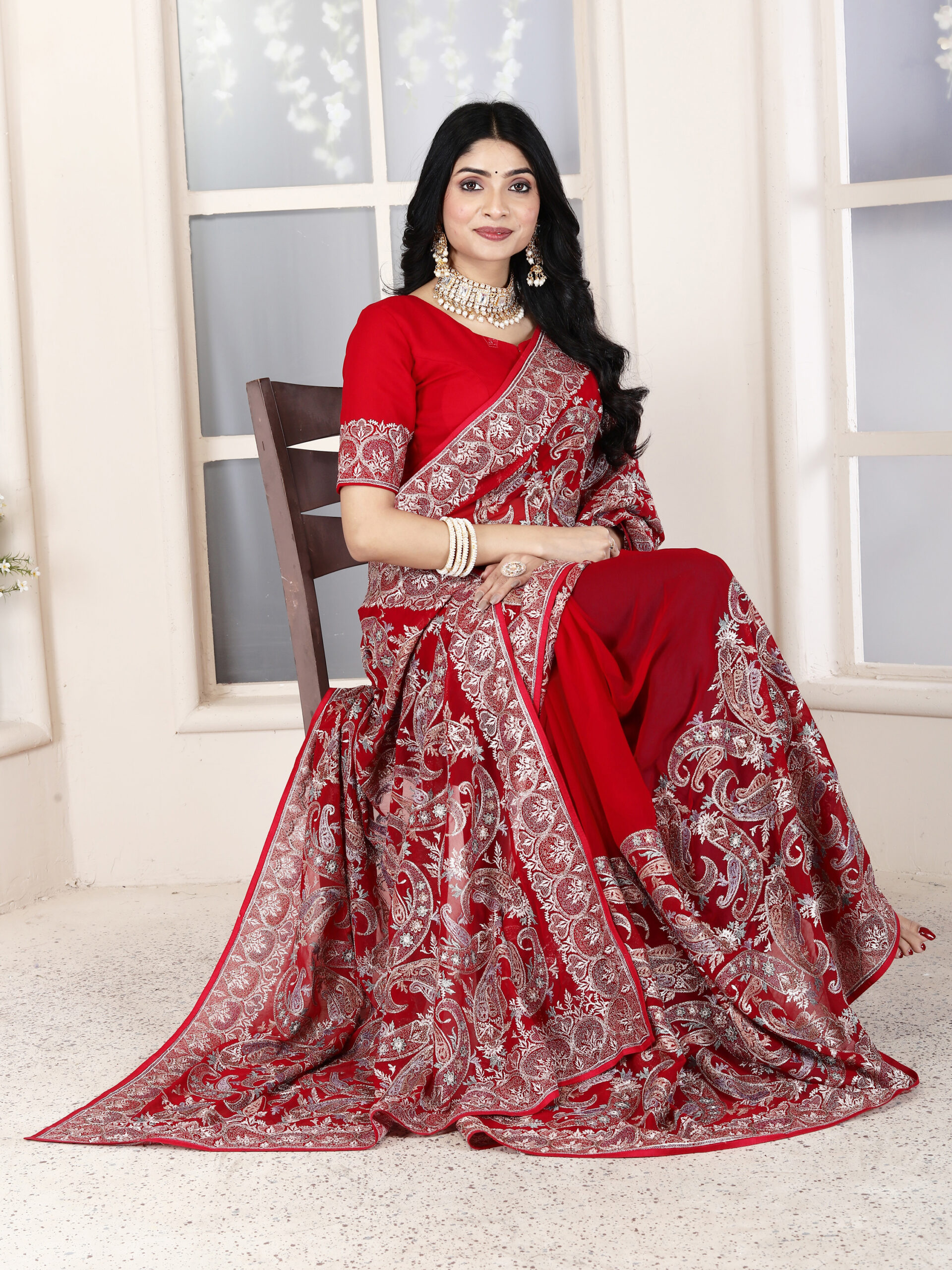 red georgette saree with metallic threadwork and a traditional embroidered border by Ritual Styles.