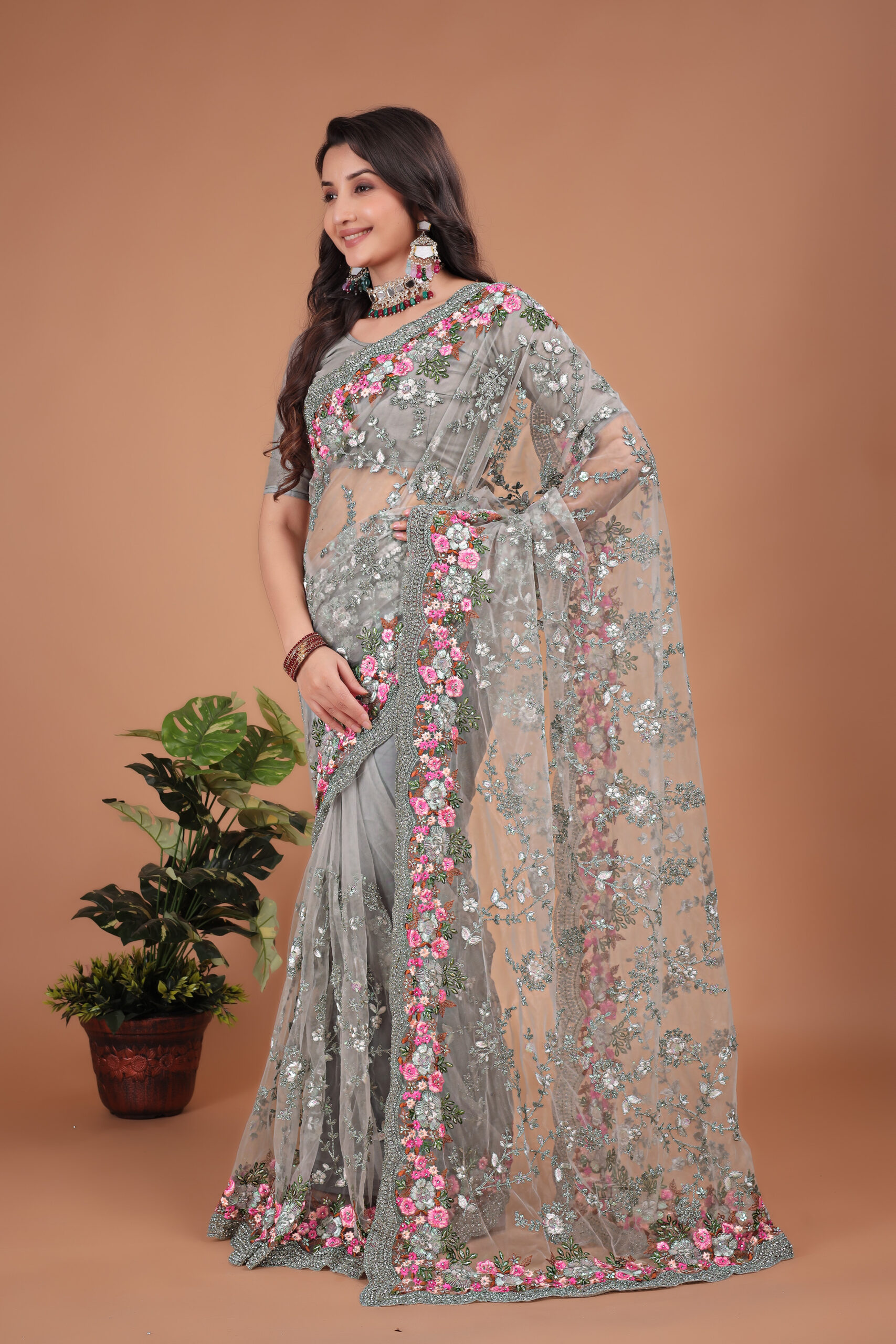 Grey Net Saree with Swarovski work and a detailed floral embroidered border by Ritual Styles.